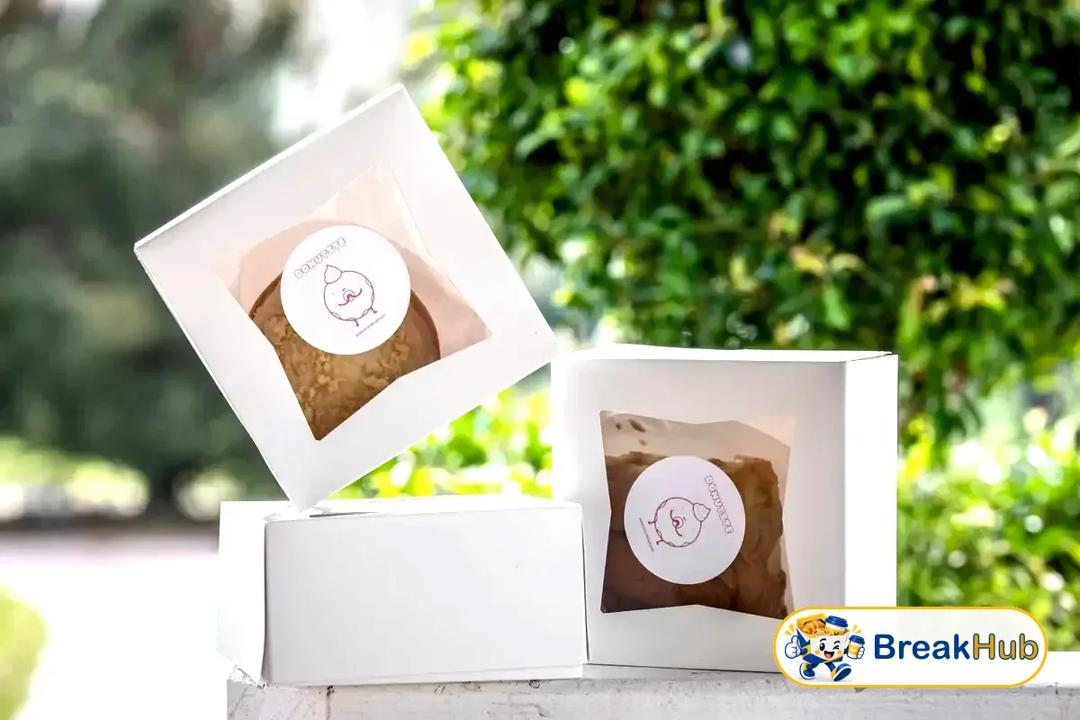 Premium bakery box holding several pastries (illustration)