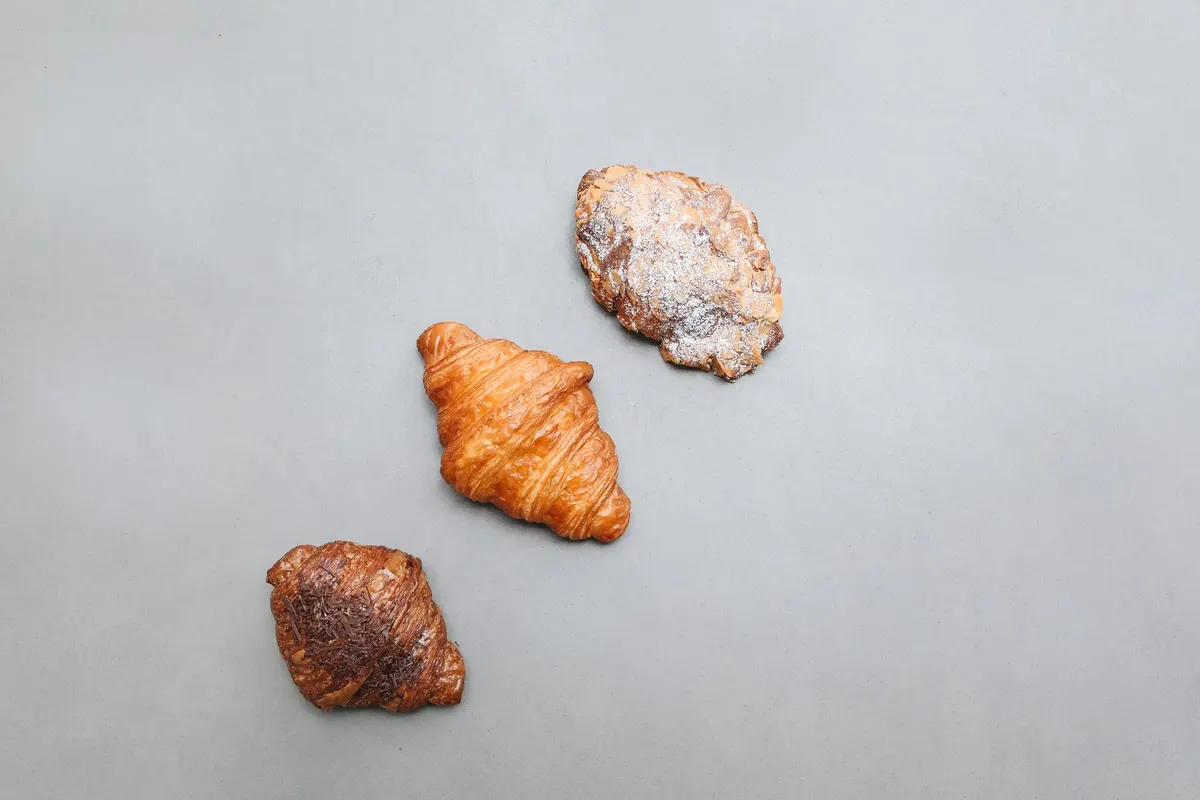 Assorted croissants in a bakery box (illustration)